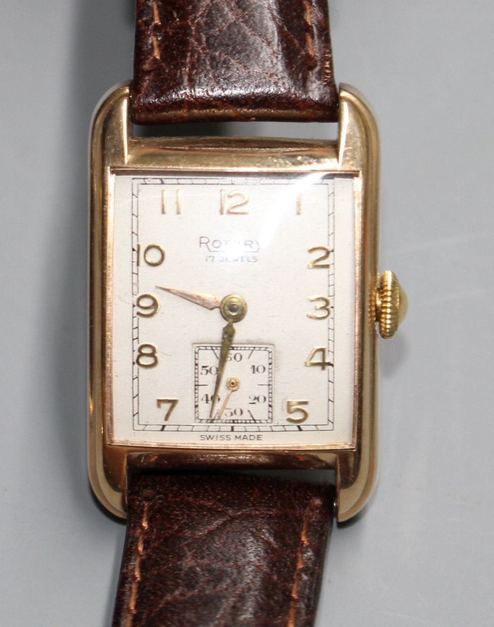 A gentlemans early 1950s 9ct gold Rotary manual wind wrist watch, the rectangular dial with Arabic numerals and subsidiary seconds,